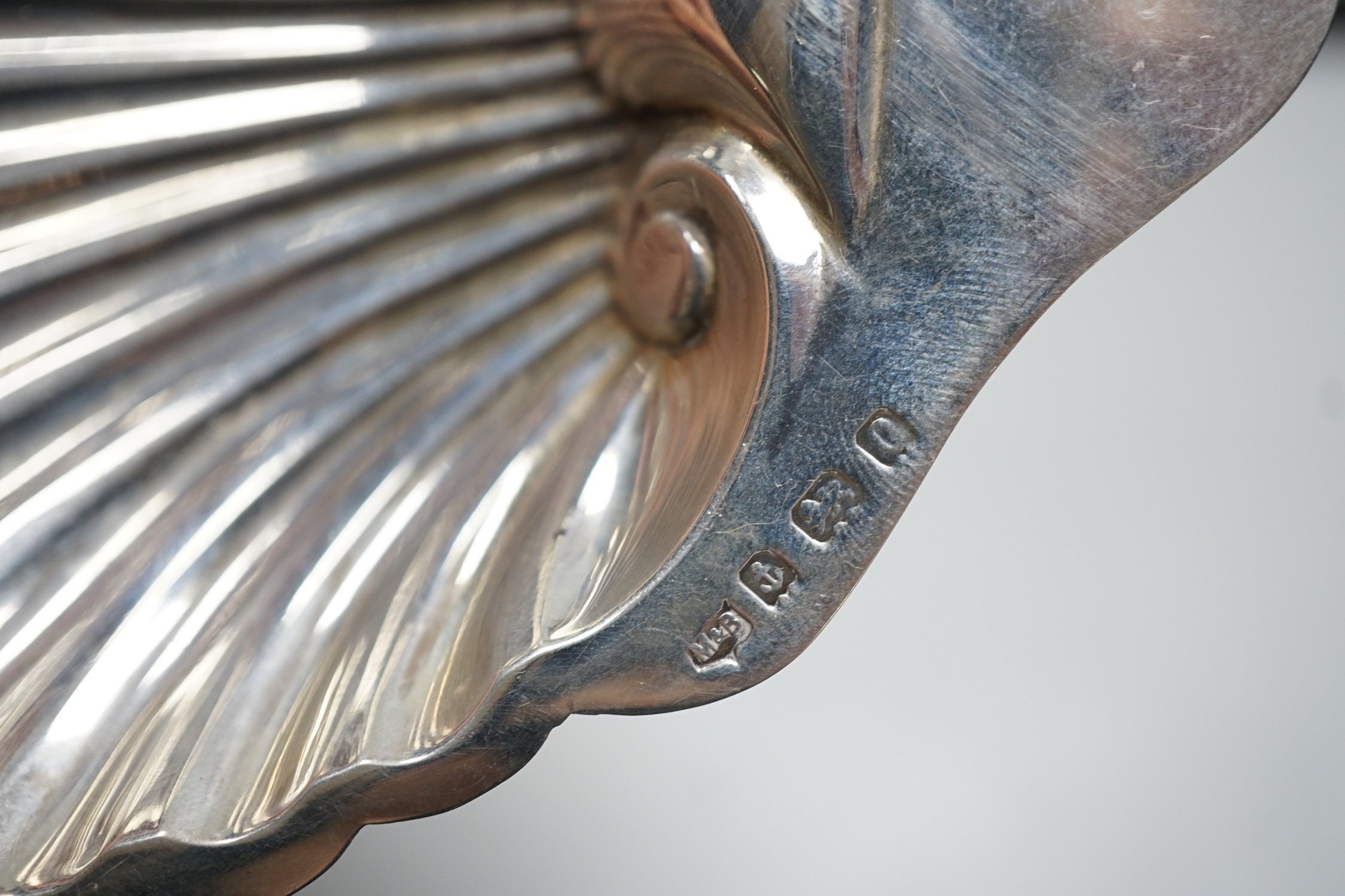 A set of six tea knives, an Edwardian silver butter shell and knife and a set of six silver coffee spoons, all cased.